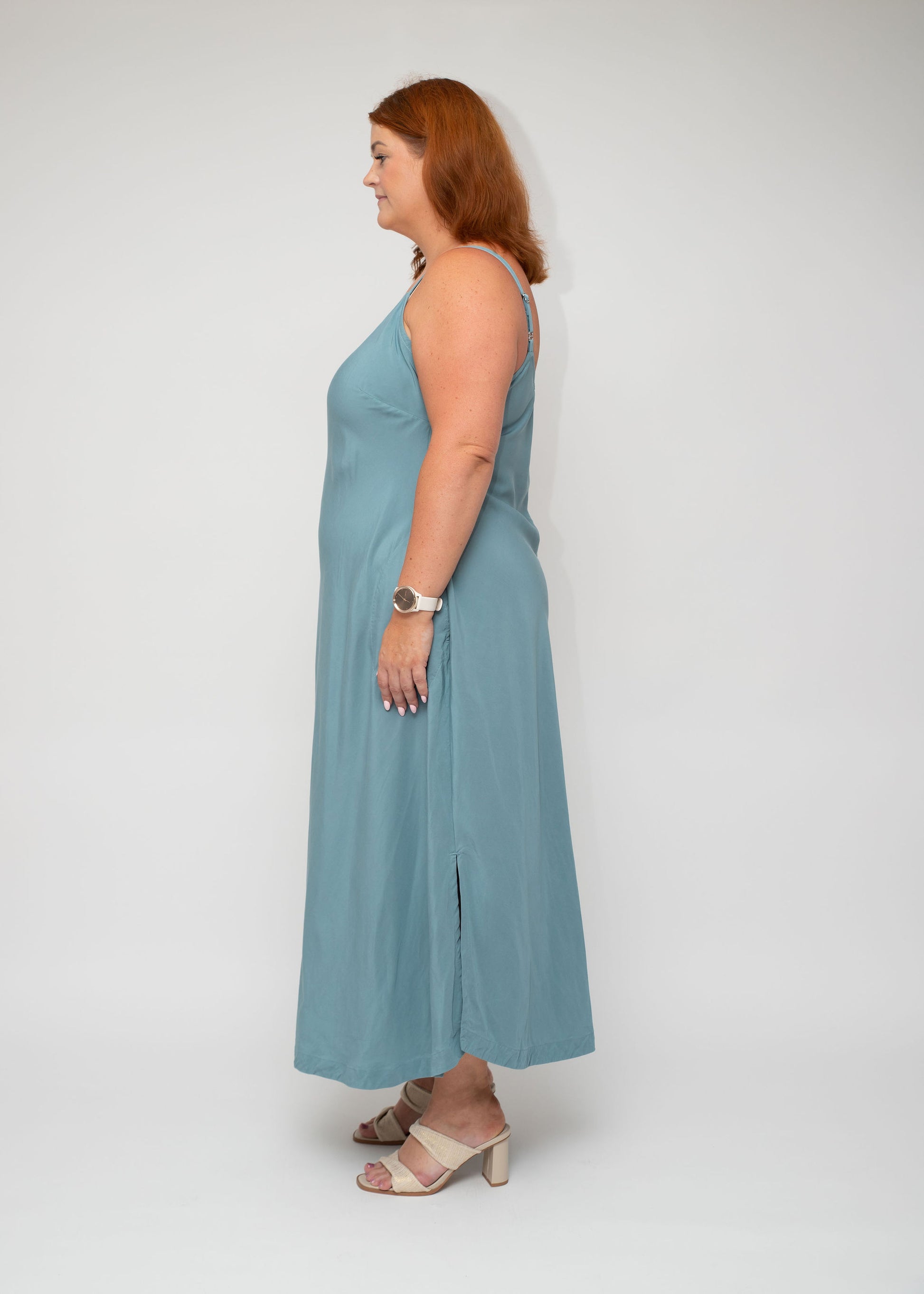 Side view of the Sage Green Slip Dress, highlighting the soft fabric flow and adjustable straps, designed for curvy women seeking both style and comfort.