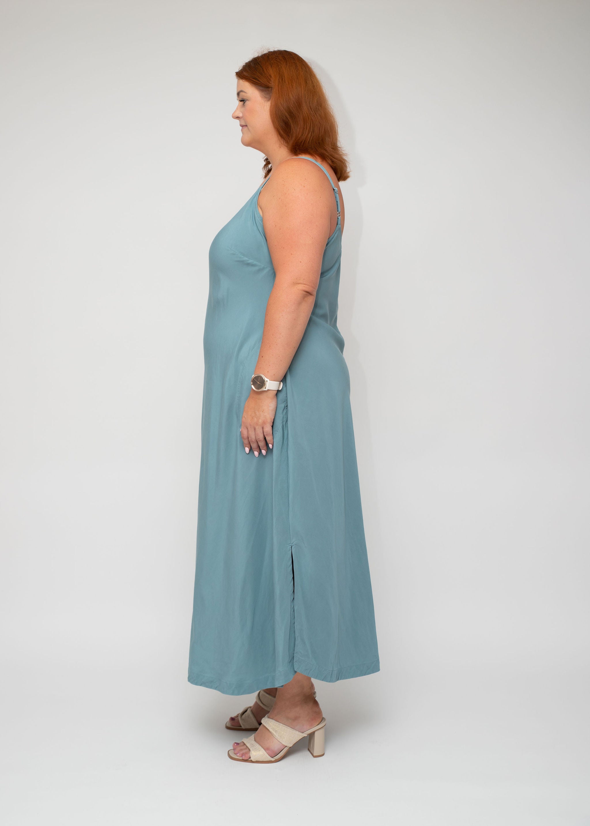 Side view of the Sage Green Slip Dress, highlighting the soft fabric flow and adjustable straps, designed for curvy women seeking both style and comfort.