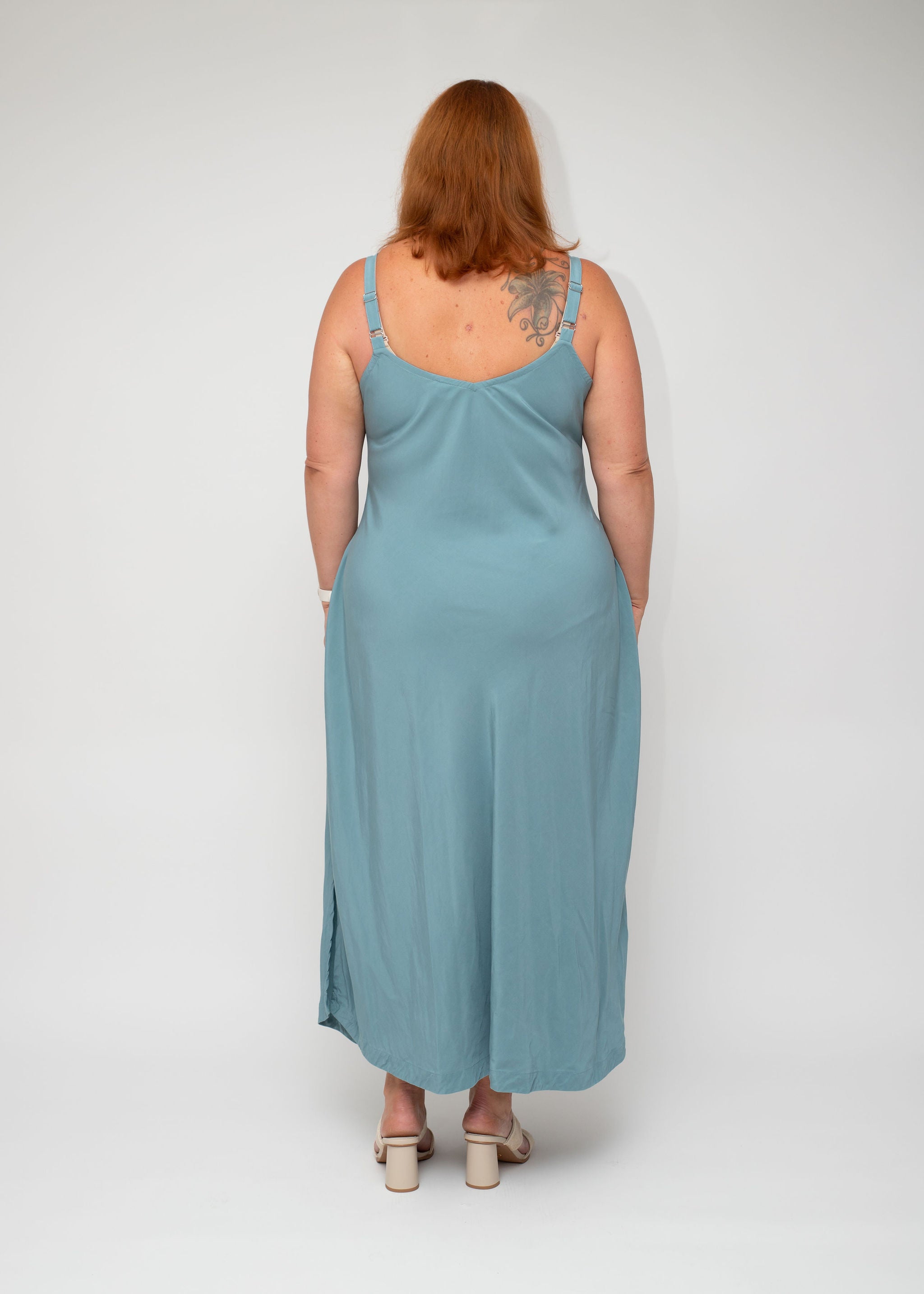 Back view of the Sage Green Slip Dress, showcasing the smooth back design and effortless drape, part of the I Feel Pretty curvy collection.