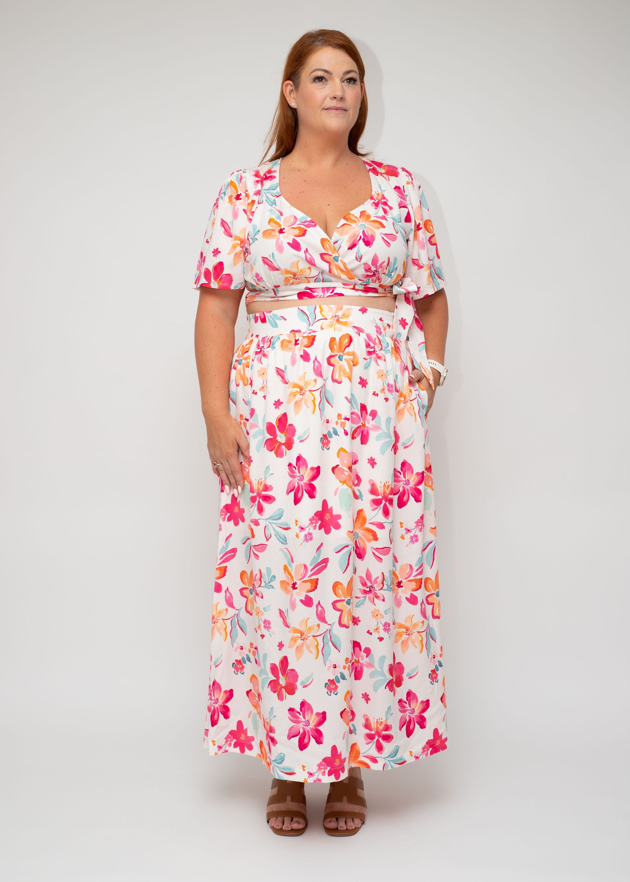 Front view of the Spring Bloom Wrap Top and Spring Mood Maxi Skirt from the Curvy Collection by I Feel Pretty, showcasing its vibrant floral design and functional pockets.