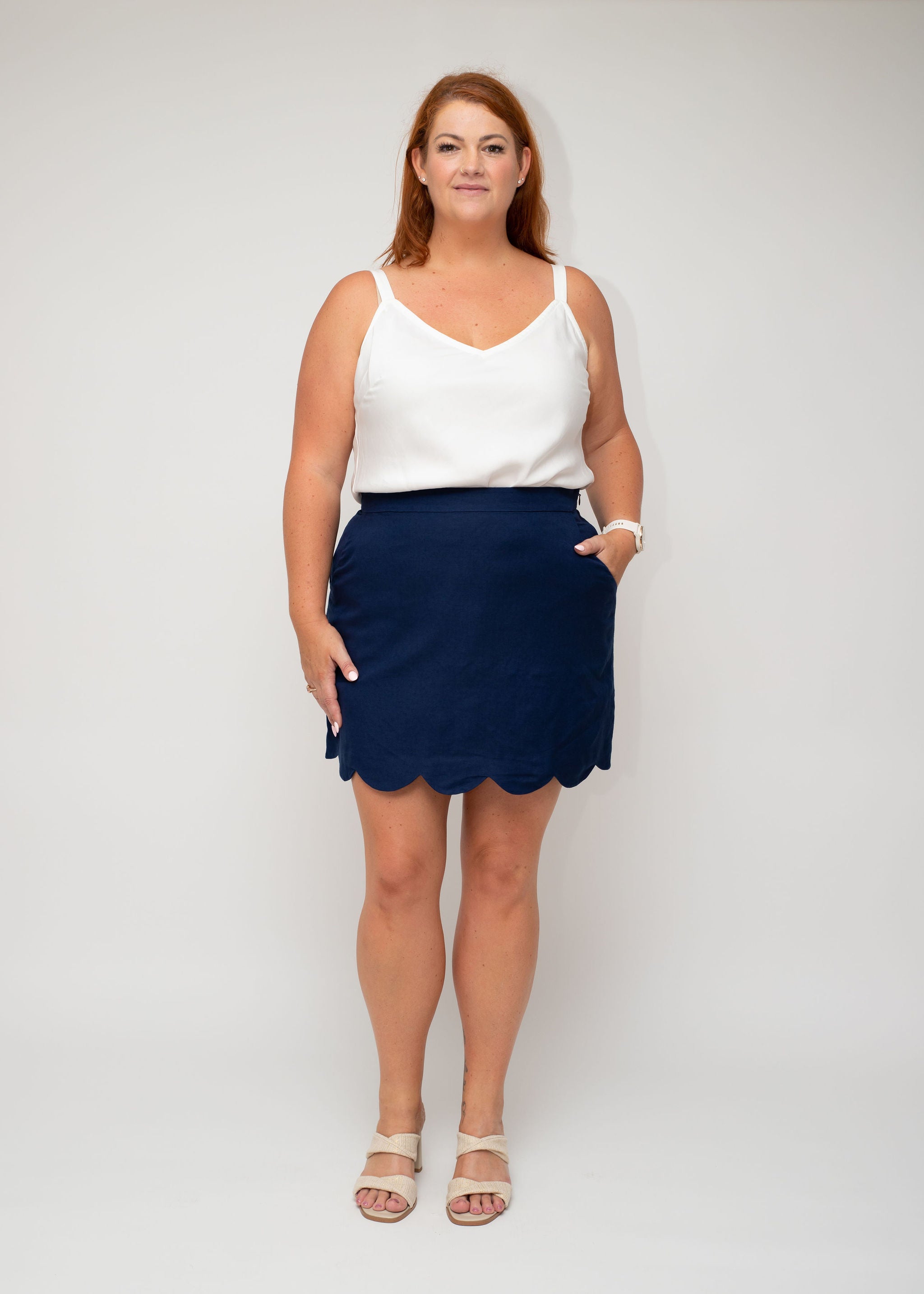 Front view of the White Linen Slip Top paired with the Navy Linen Mini Skirt featuring a scallop hem, part of the Curvy Women Collection by I Feel Pretty. The skirt includes convenient pockets for functionality.