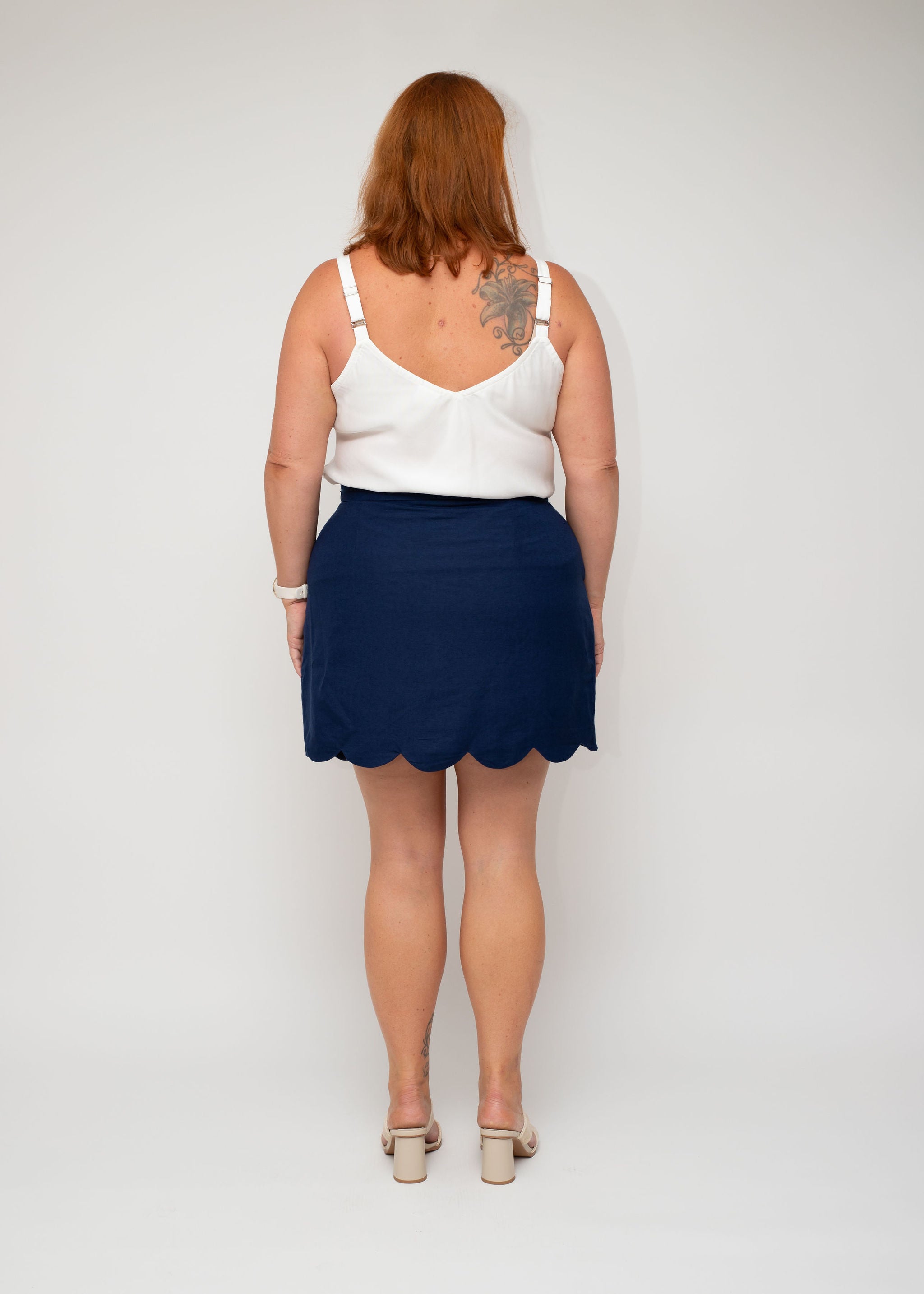 Back view of the White Linen Slip Top and Navy Linen Mini Skirt, emphasising the smooth fabric finish and seamless design by I Feel Pretty for their curvy collection.