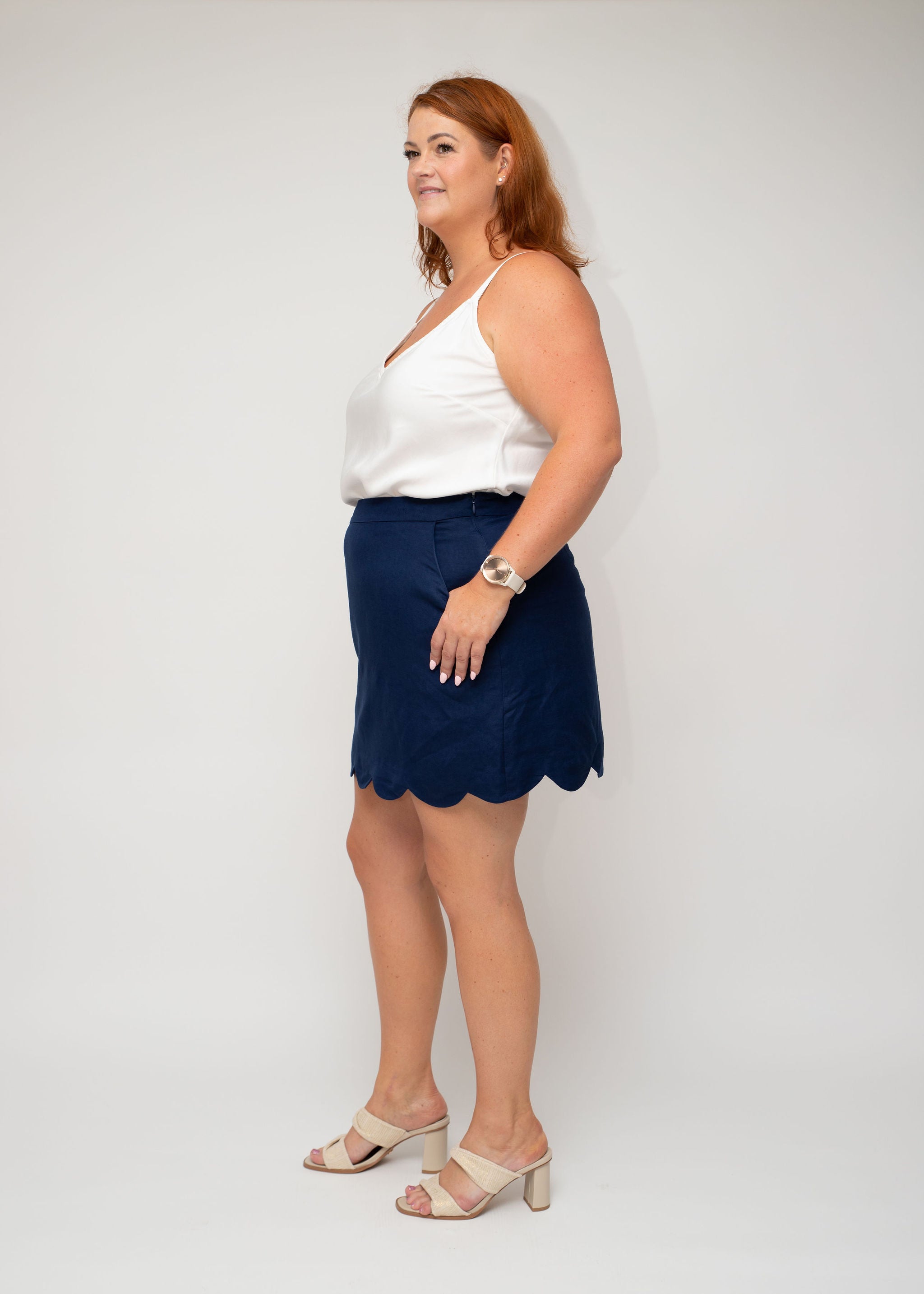 Side profile of the White Linen Slip Top and Navy Linen Mini Skirt, highlighting the scallop hem detail and tailored fit for curvy women from I Feel Pretty's range.