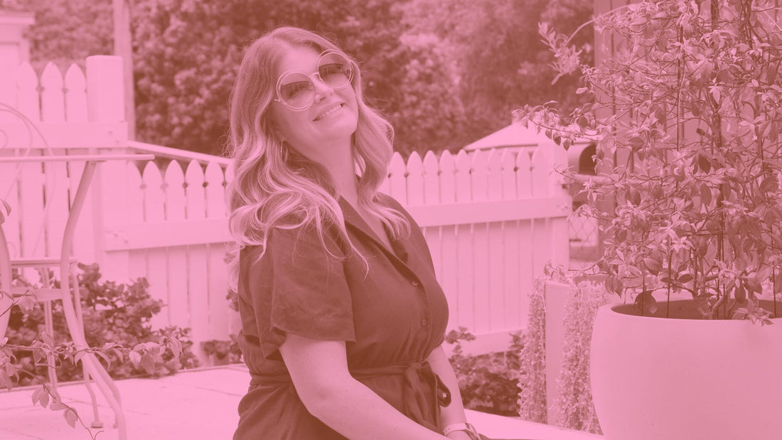 A woman smiling outdoors in a garden while wearing a linen dress from I Feel Pretty Boutique, showcasing sustainable plus-size fashion in Australia.